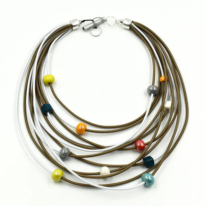 A multi-strand necklace featuring brown and white cords accented with small colorful beads in yellow, orange, red, teal, gray, and cream, displayed on a clean white background.