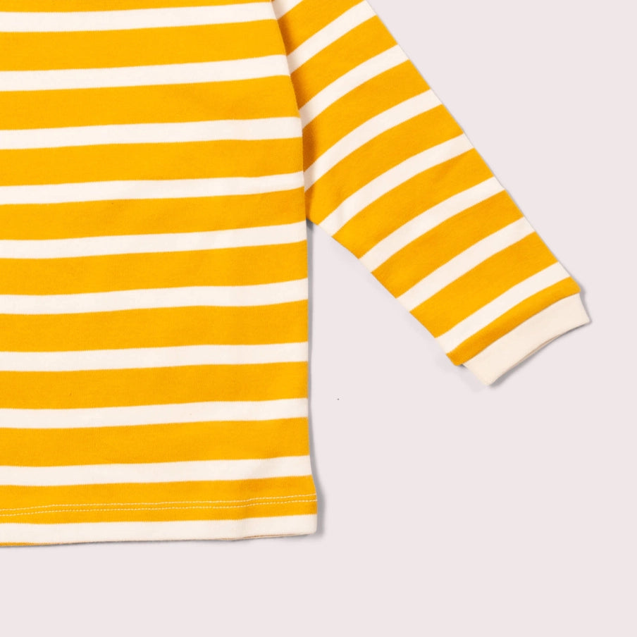 Close-up of a yellow and white striped long-sleeve shirt on a light gray background