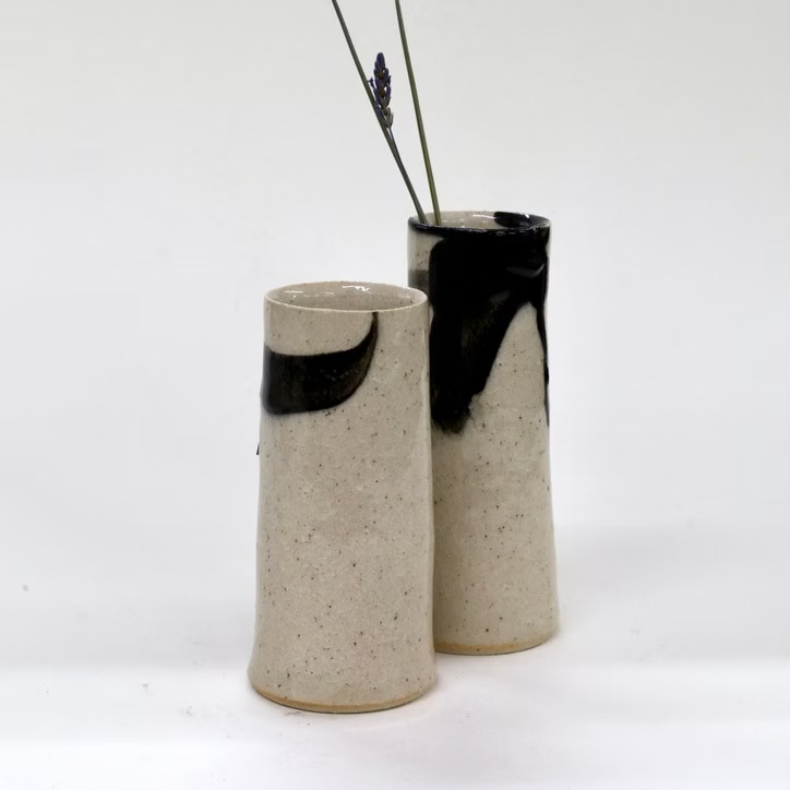 Two ceramic vases with black accents on a white background