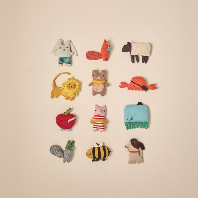 Collection of small animal figurines on a beige background