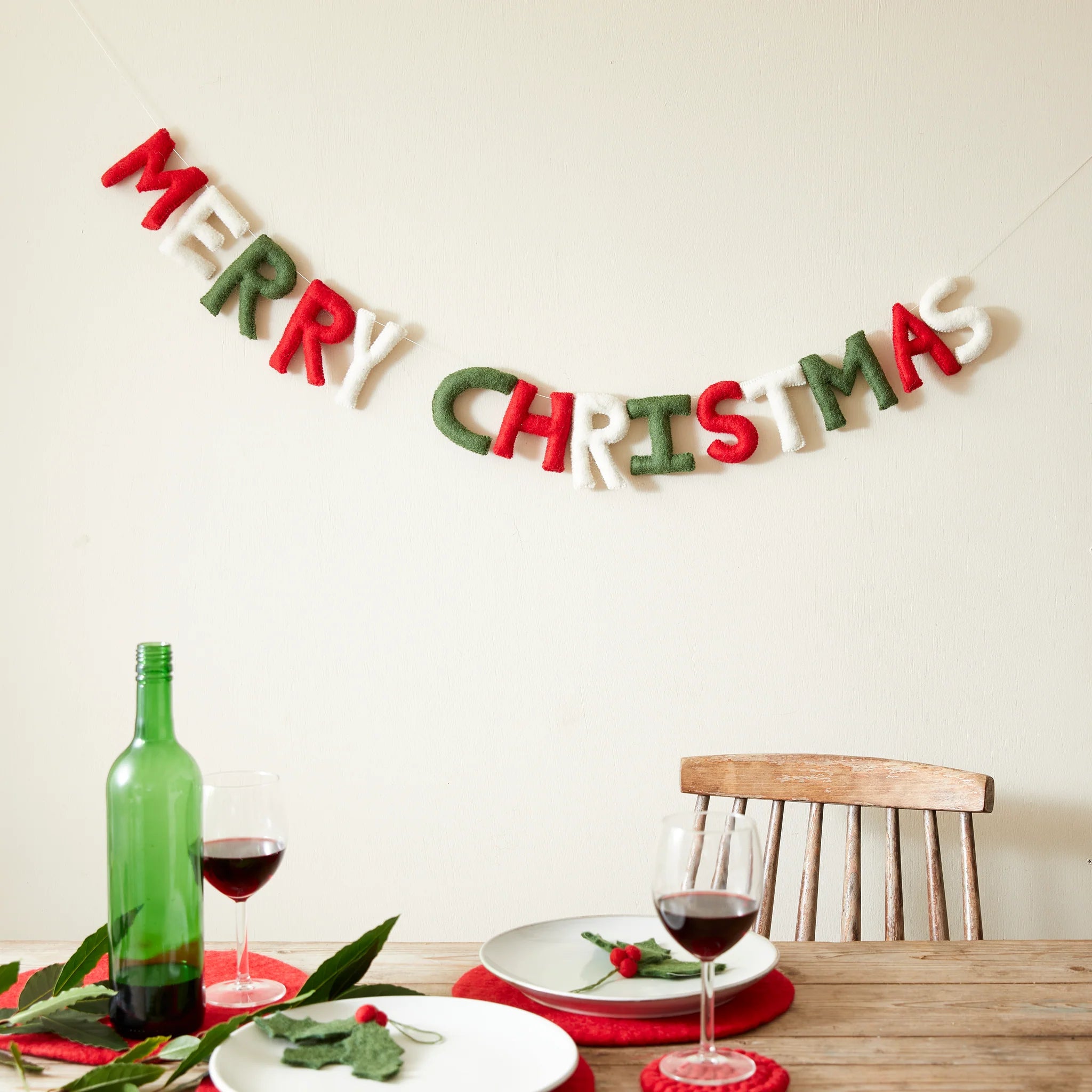Red, green, and white felt letter garland spelling "Merry Christmas."
