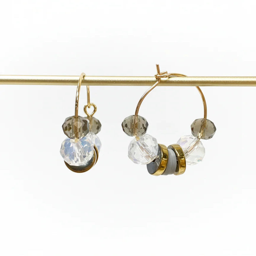 Gold hoop earrings with clear and gold beads on a white background