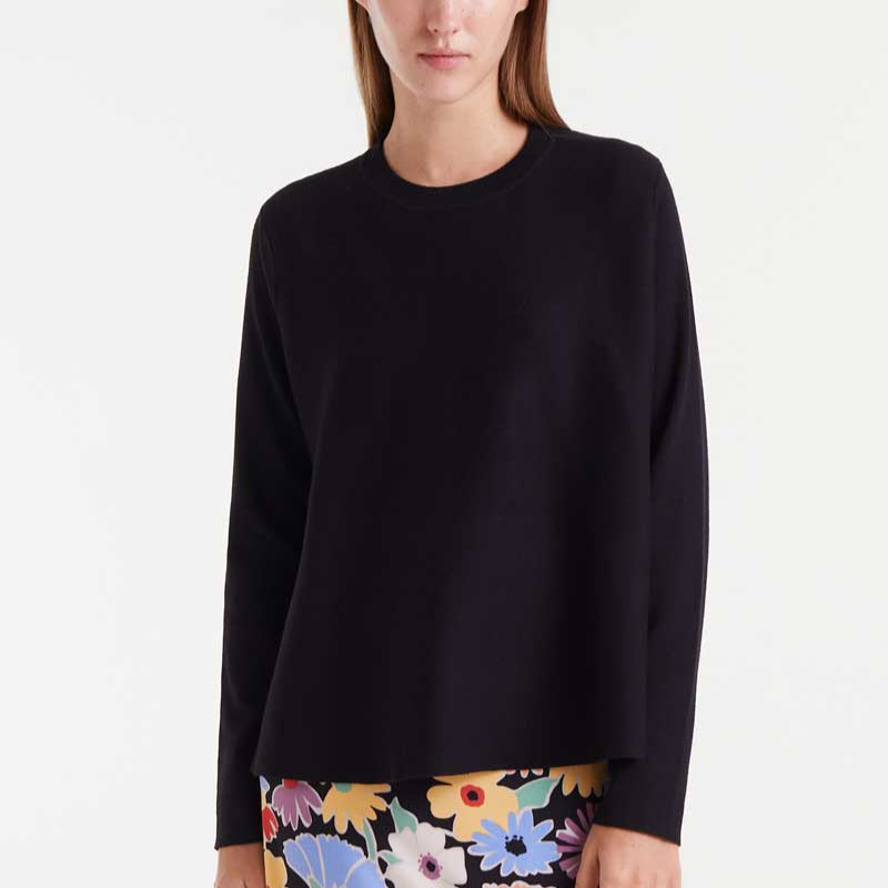 Black sweater with colorful floral pattern at the hem on a white background