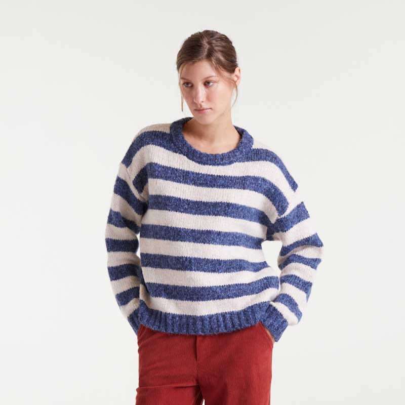 Person wearing a blue and white striped sweater on a white background