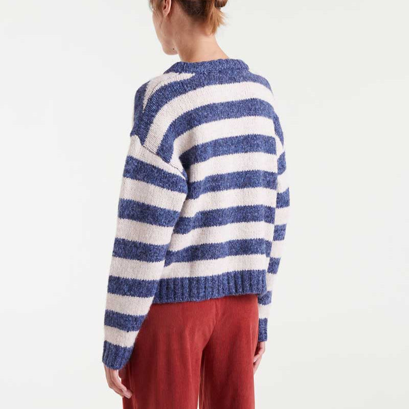 Person wearing a blue and white striped sweater on a white background