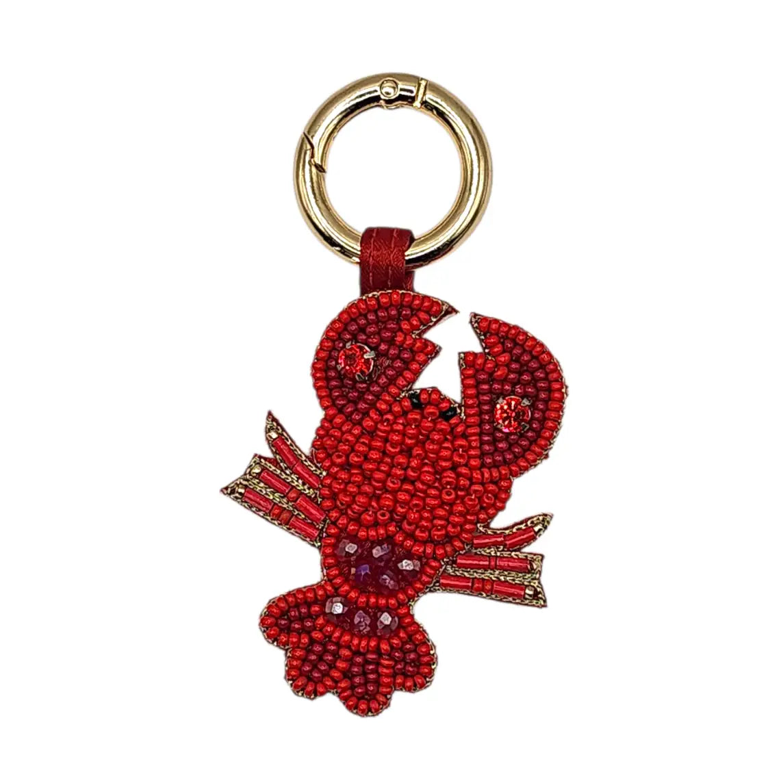 A lobster-shaped keychain charm embellished with red seed beads and rhinestones, attached to a red leather loop and a gold-tone split ring, shown on a plain white background.