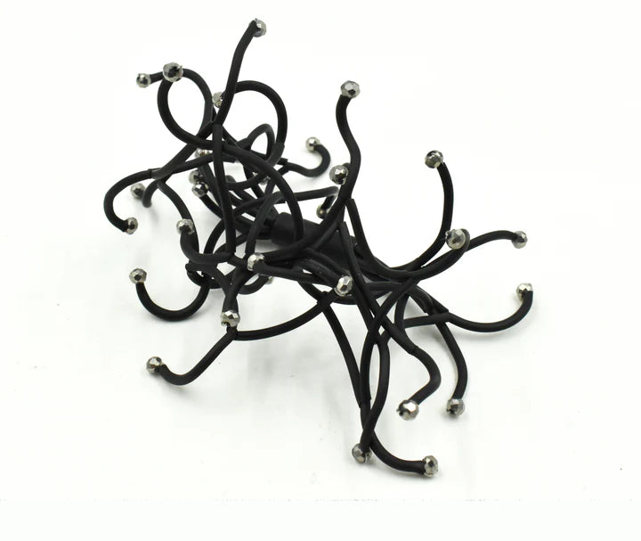 Black hair tie with numerous thin, curved strands and small silver-toned beads.