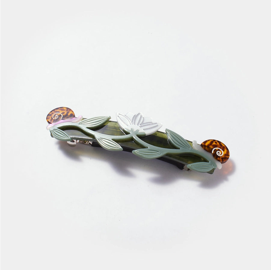 Decorative hair clip with leaf and butterfly design on a white background