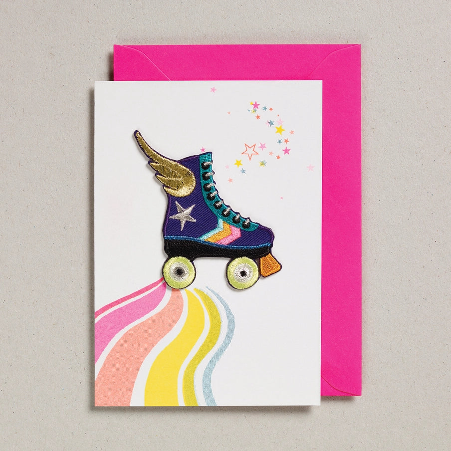 Greeting card with a colorful roller skate design on a pink envelope.