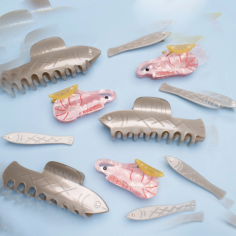 Fish-shaped hair clips on a light blue background