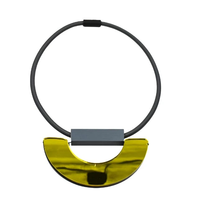 Gold and gray statement necklace with a circular band and a half-moon pendant.