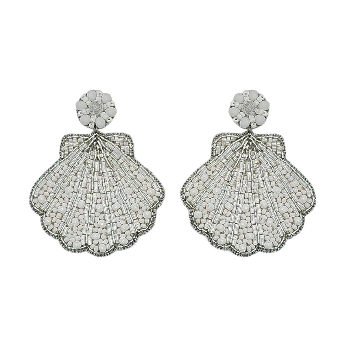 A pair of large, intricate shell-shaped drop earrings with scalloped edges, featuring a textured pavé design in silver-toned metal and clear stones, set against a plain white background.