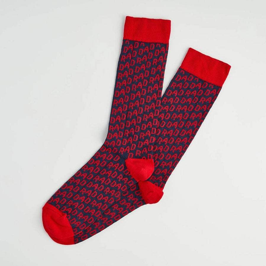 Pair of red and blue patterned socks on a light gray background