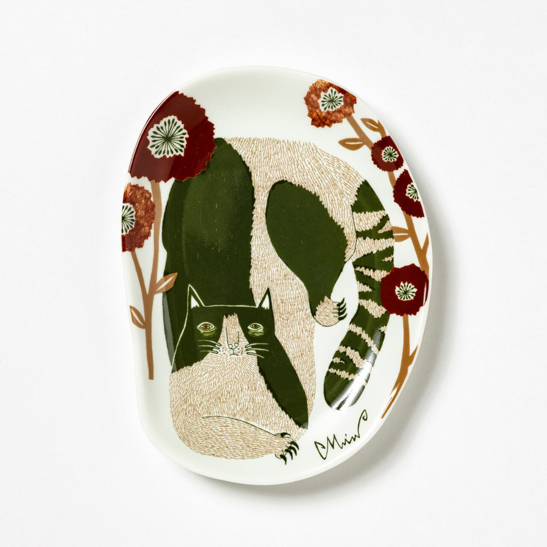 Decorative plate with a cat and floral design on a white background