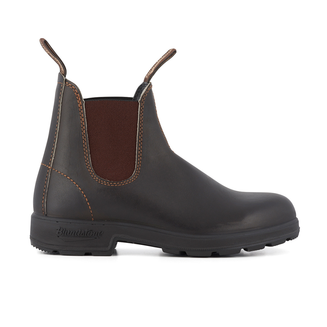 Dark brown leather Blundstone Chelsea boot with a textured rubber sole.  Orange stitching accents the elastic side panels.