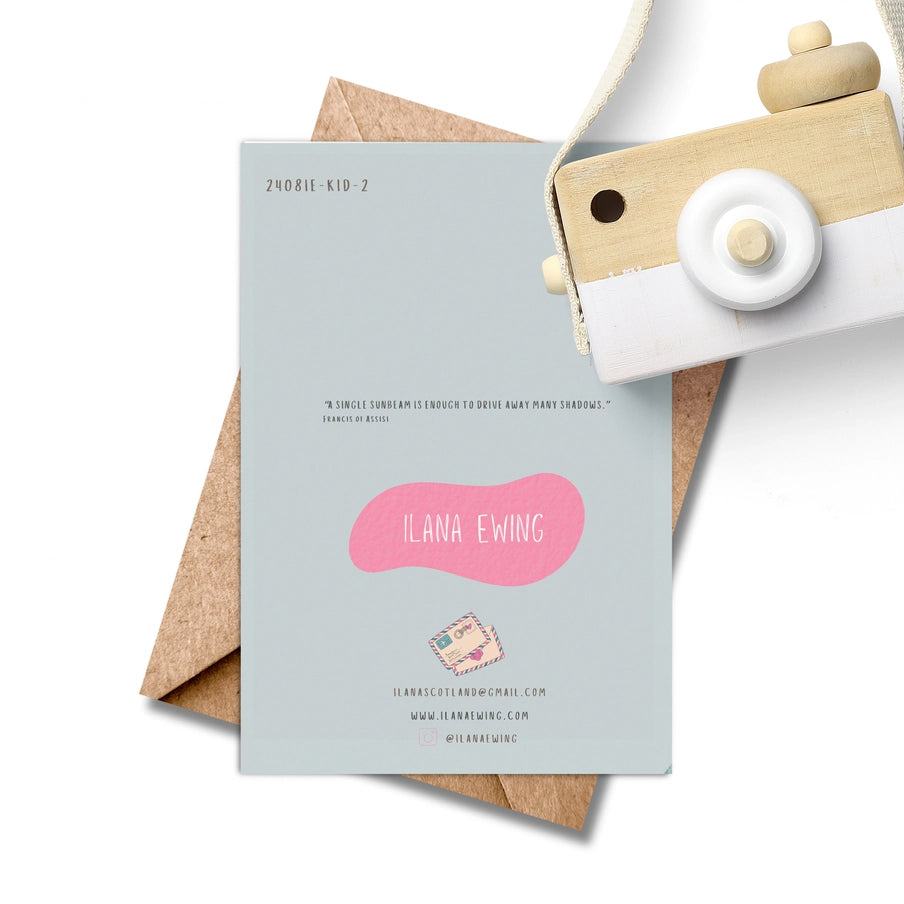 Light blue greeting card with pink artist's name, Ilana Ewing, contact info, and a quote by Francis of Assisi.