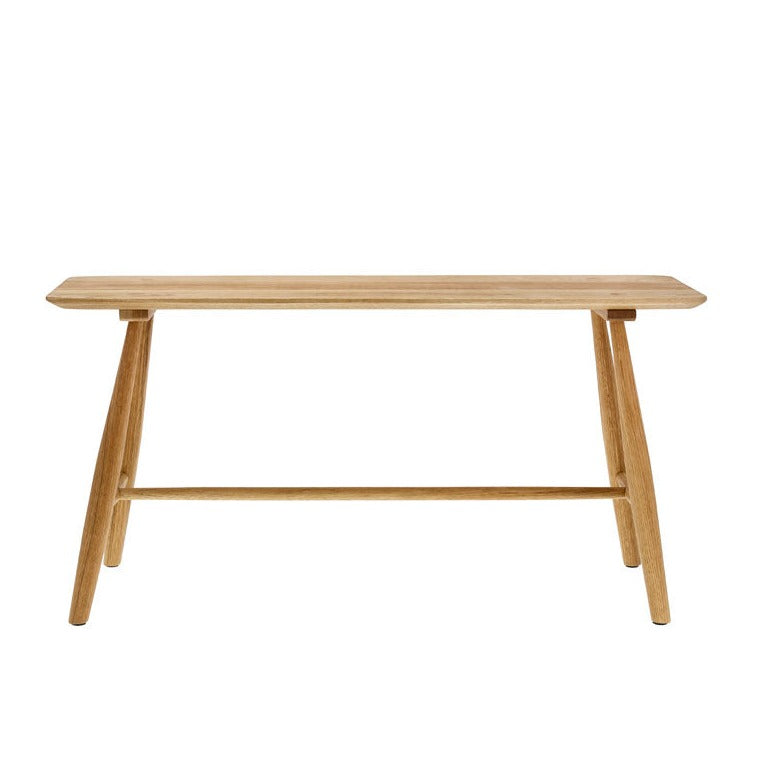 Light oak wood bench with a rectangular top and slightly splayed legs, featuring a single, low horizontal support bar.