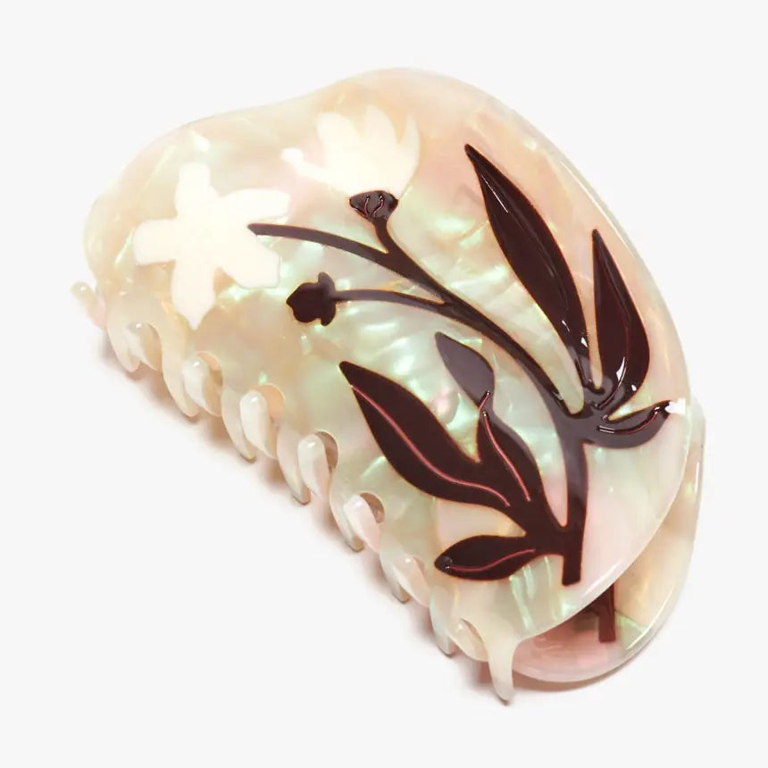 Decorative hair clip with floral design on a white background
