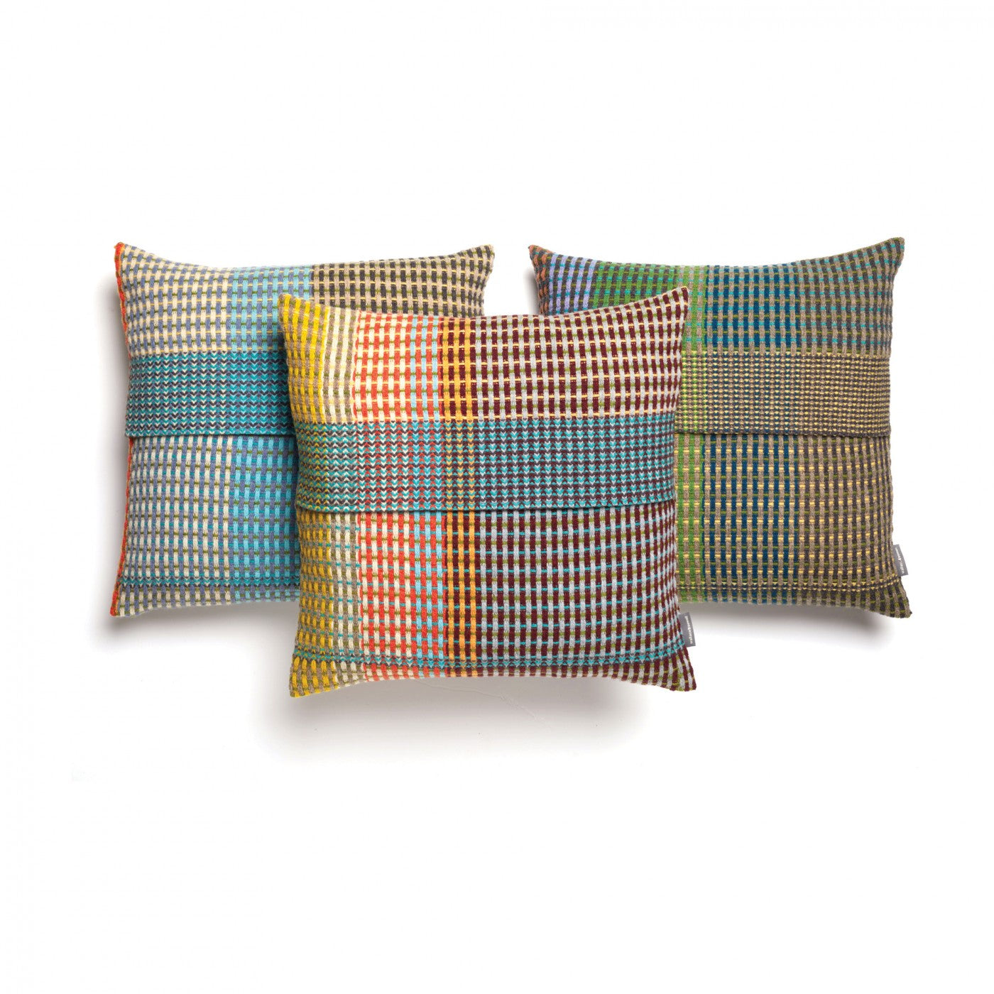 Three square throw pillows with multicolored woven plaid patterns.