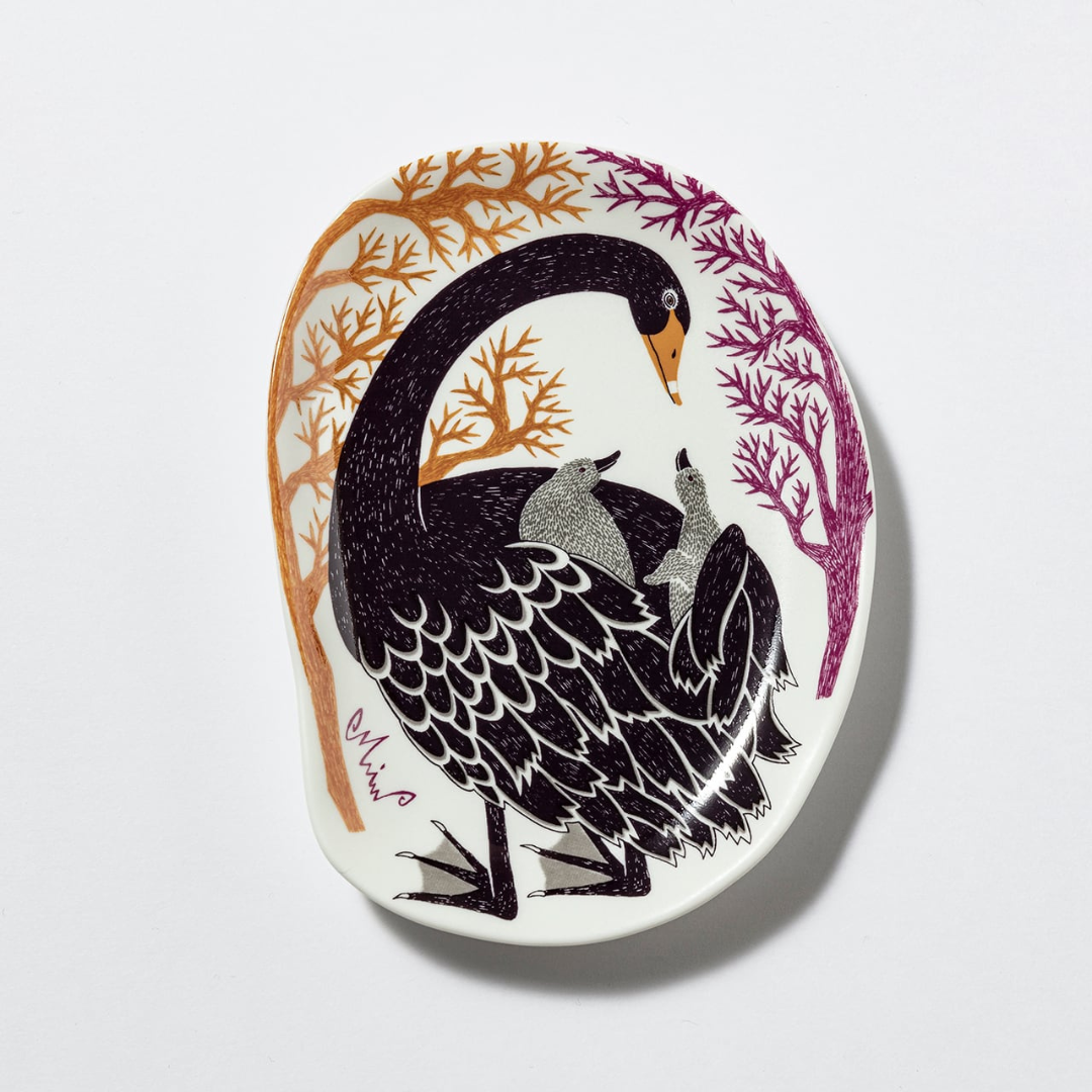 Decorative plate with black swan design on a white background