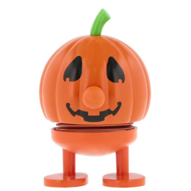 Orange pumpkin-shaped toy with a jack-o'-lantern face and short legs.