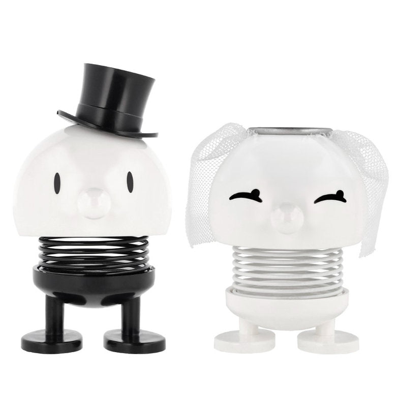 Pair of bobblehead wedding figurines on springs.  The groom wears a top hat; the bride has a veil.