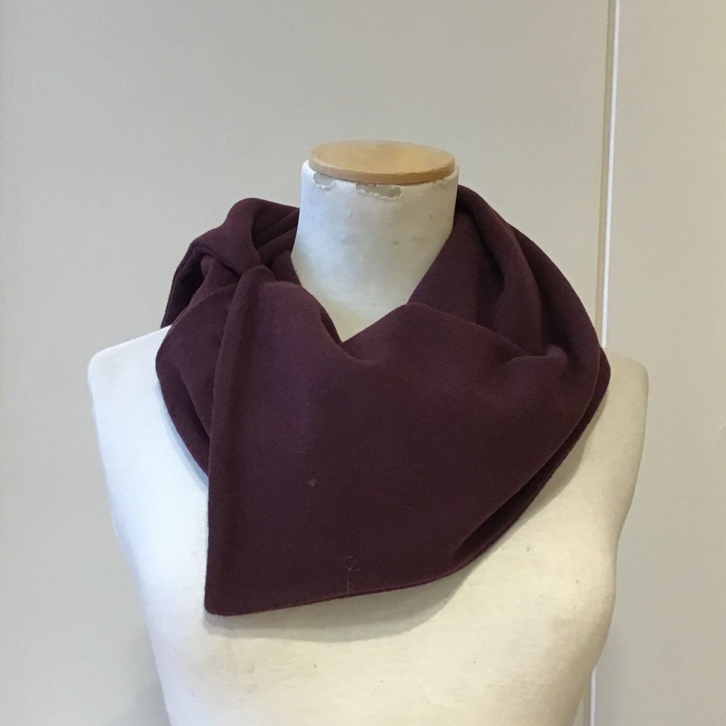 Burgundy cowl neck infinity scarf displayed on a mannequin.  The scarf is made of a soft, possibly fleece-like material.