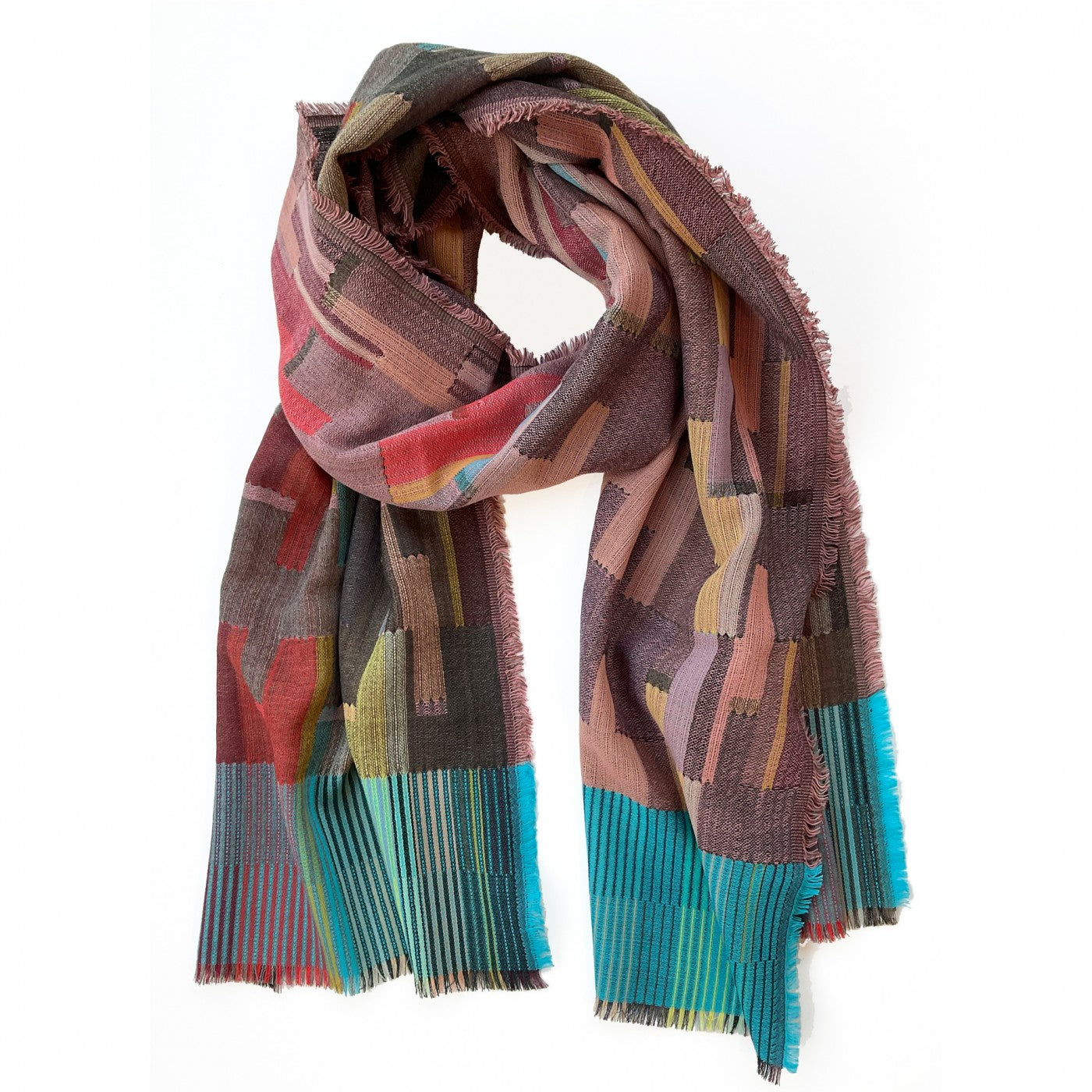 Woven scarf with abstract geometric pattern in muted pinks, reds, teal, and grays.  Frayed edges.