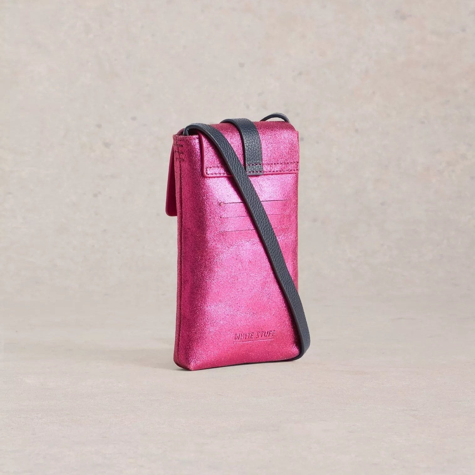 Pink metallic leather crossbody phone bag with a dark gray strap.