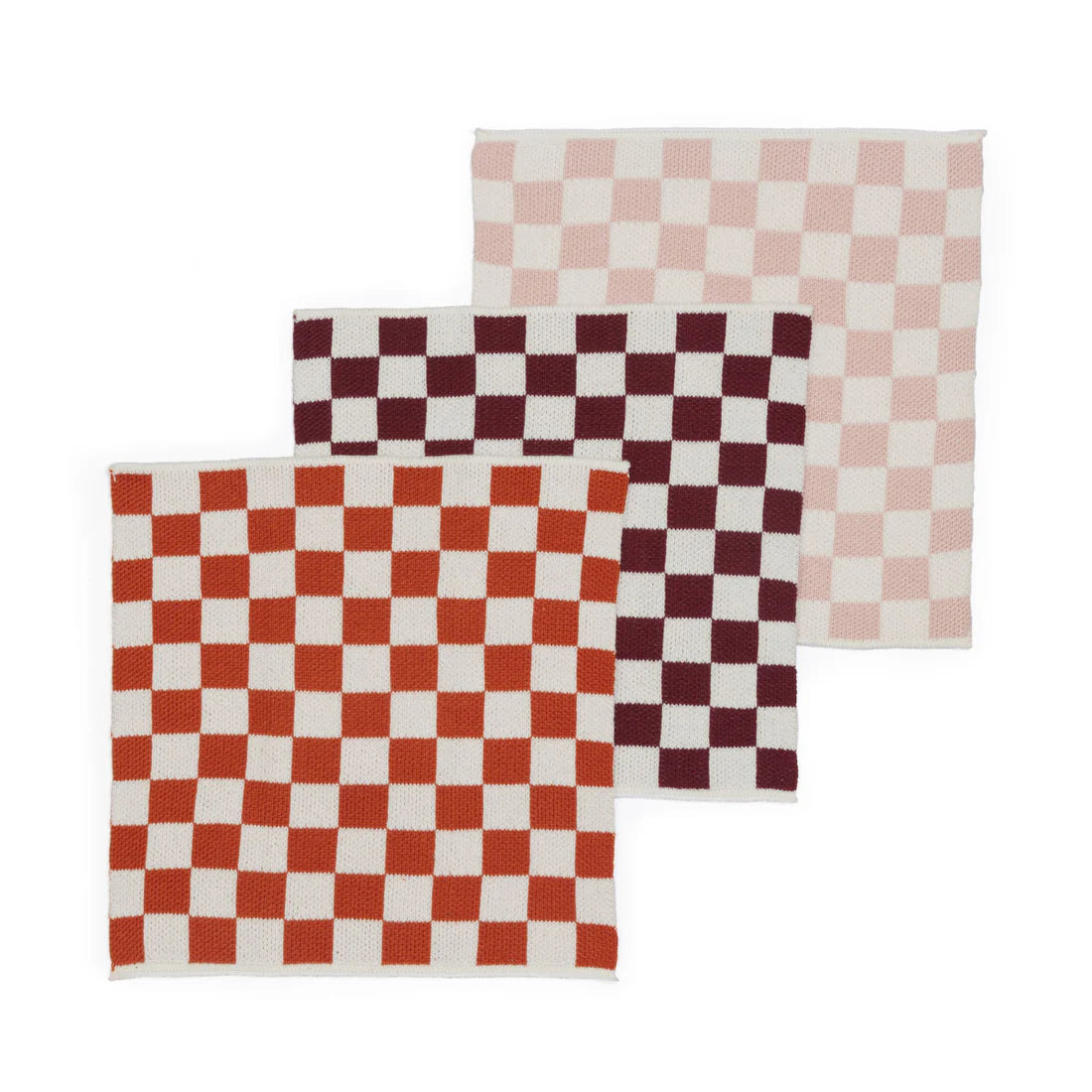 Three checkered placemats in red, white, and pink on a white background