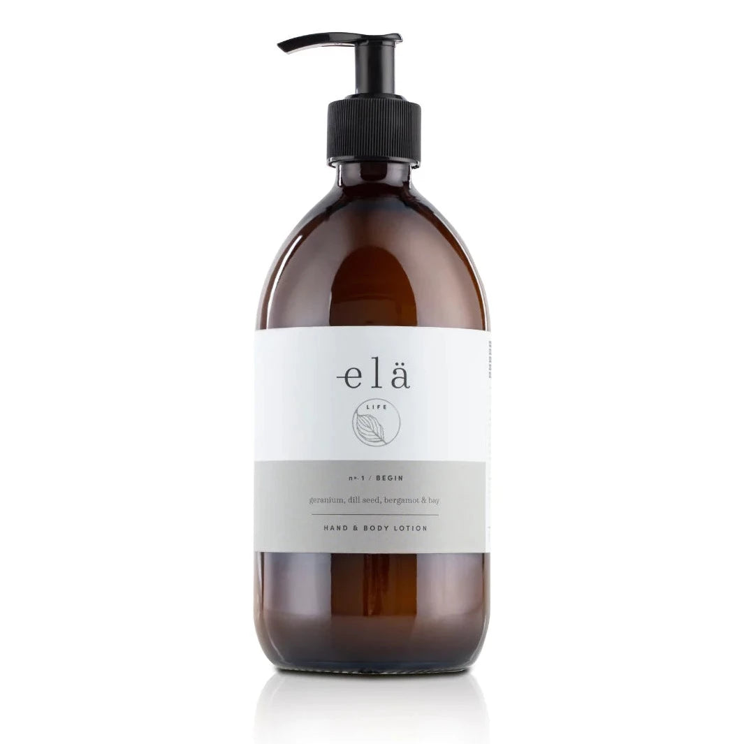 Amber glass pump bottle of elã Life hand & body lotion.  Label indicates geranium, dill seed, bergamot & bay scent.