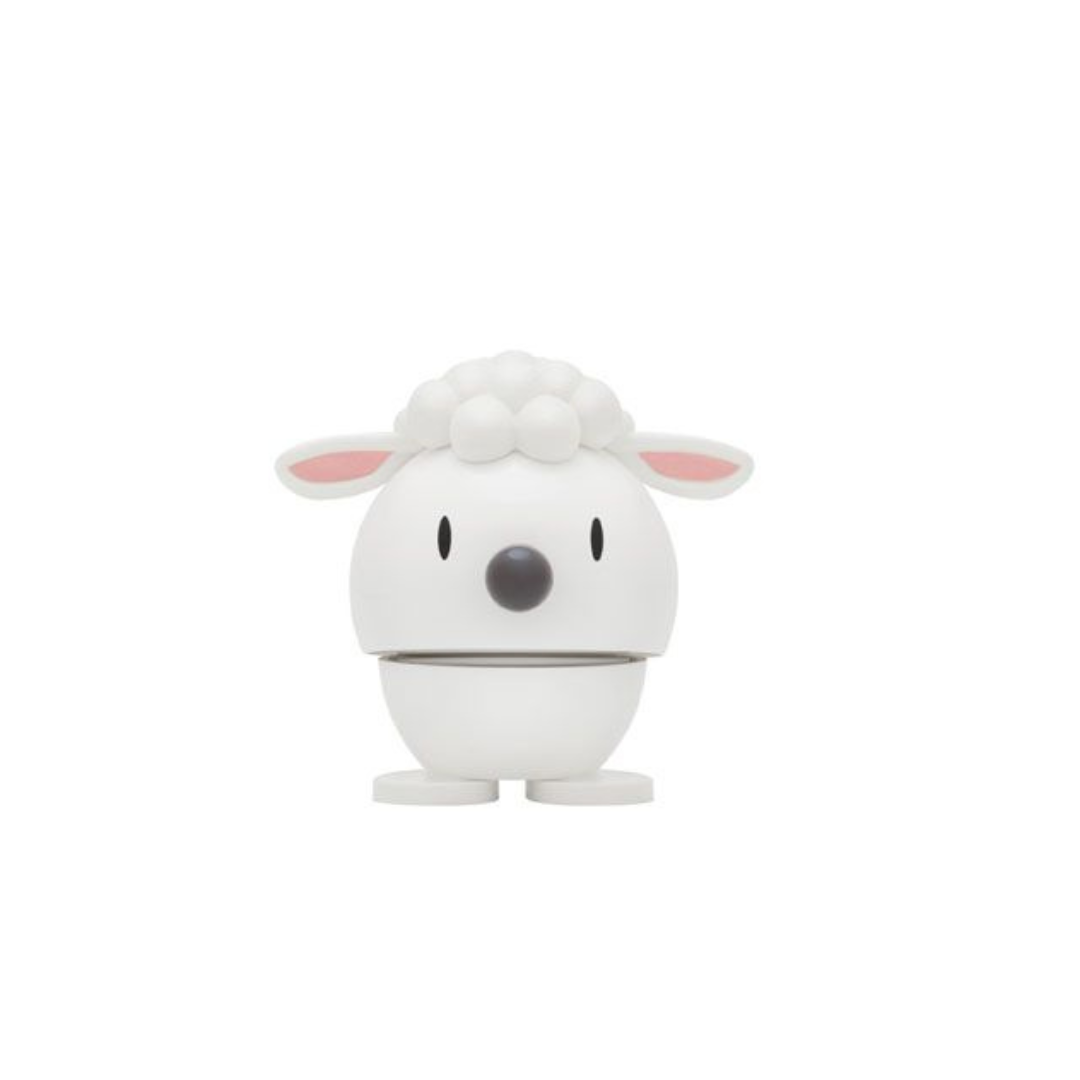 White lamb-shaped toy with small feet, pink ears, and a gray nose.