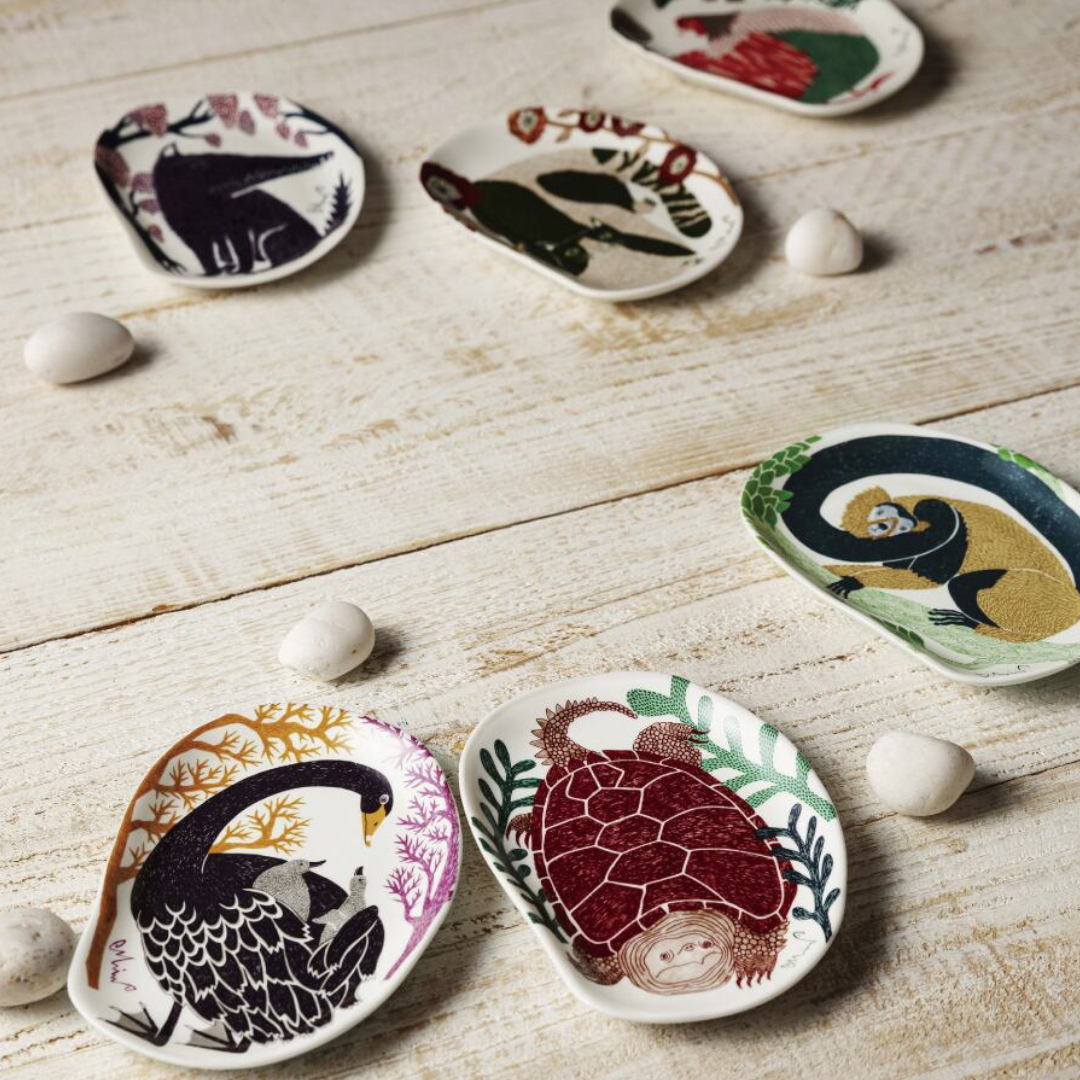 Decorative plate with black swan design on a white background