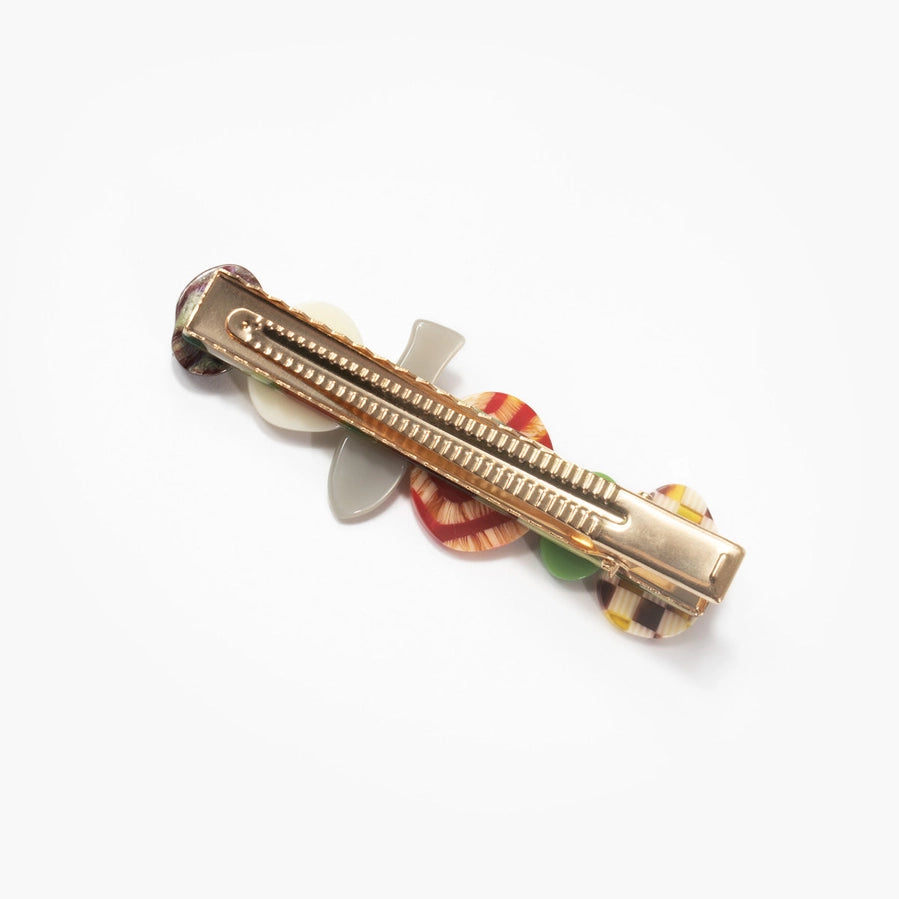 The underside of a food themed hair slide against a white background
