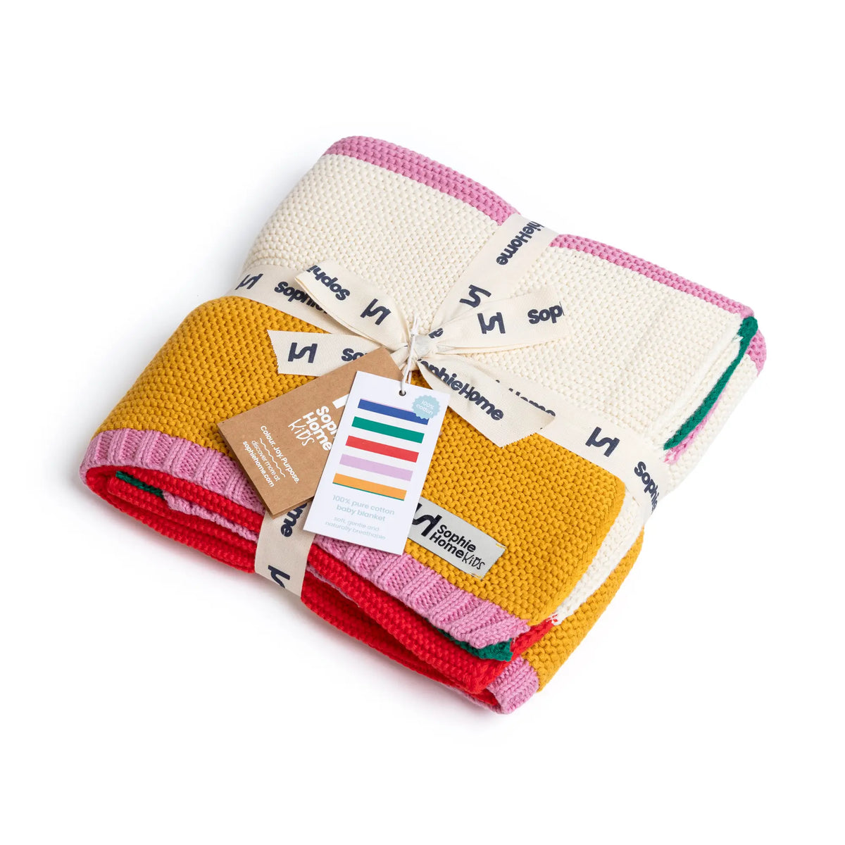 A folded knitted baby blanket by Maison Fabrique des Laitiers, featuring a cream knit body with pink and yellow stripes, a yellow center section, and red and green striped edges. It is wrapped in a branded ribbon with a color swatch tag.