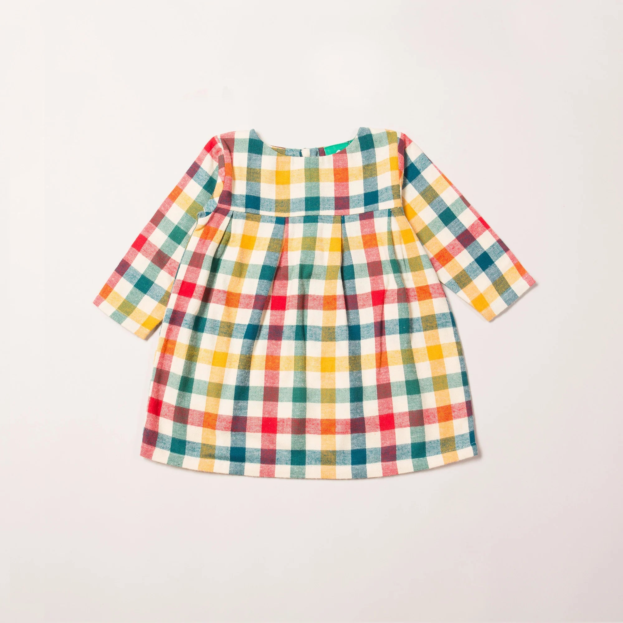 A child's long-sleeved dress with a multicolored plaid pattern in shades of red, orange, yellow, green, and cream.