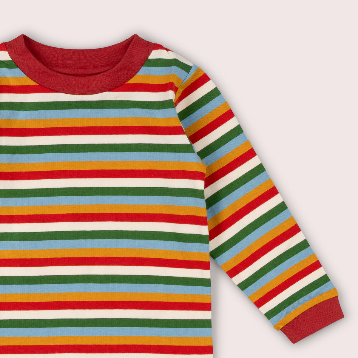 A close-up of a long-sleeve striped shirt with horizontal bands of red, green, light blue, mustard yellow, and off-white, featuring a solid red crew neck and cuffs.