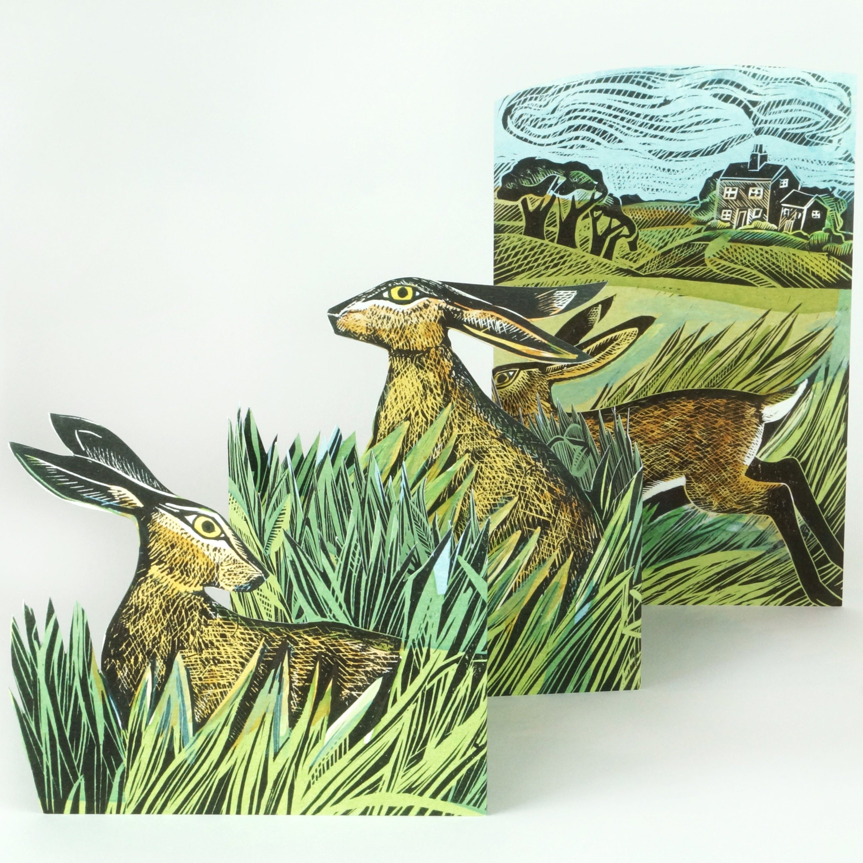 Three hares depicted in a linocut style, nestled in tall grass.