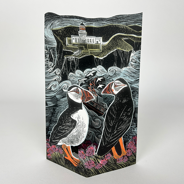 Intricate linocut-style artwork depicting two puffins perched on coastal vegetation, overlooking a lighthouse and a small