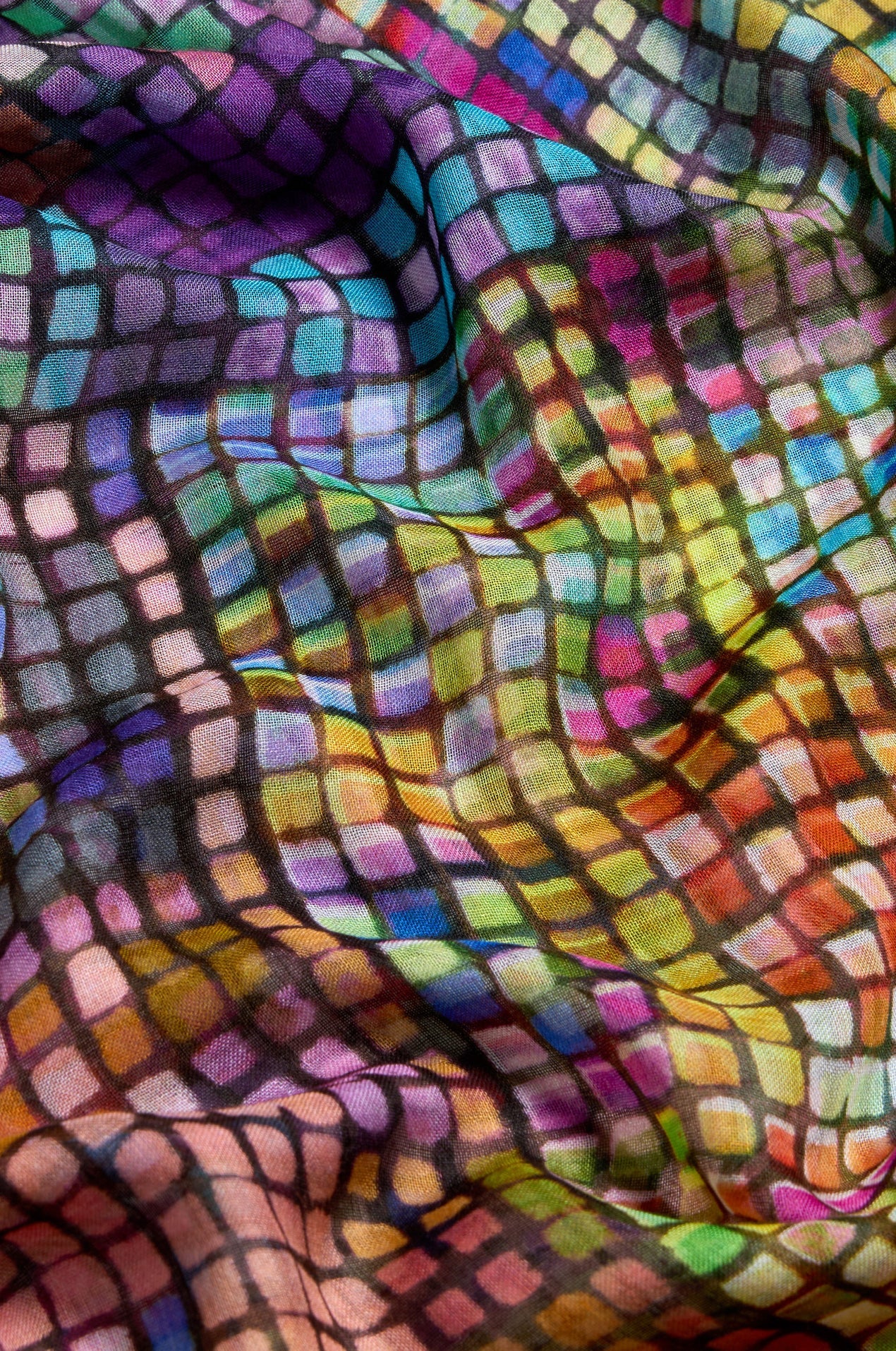 Colorful patterned fabric with a mix of purple, green, orange, and pink colors.