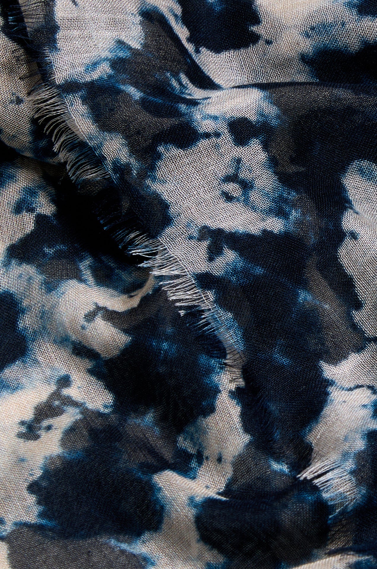 Close-up of tie-dye fabric with blue and black patterns