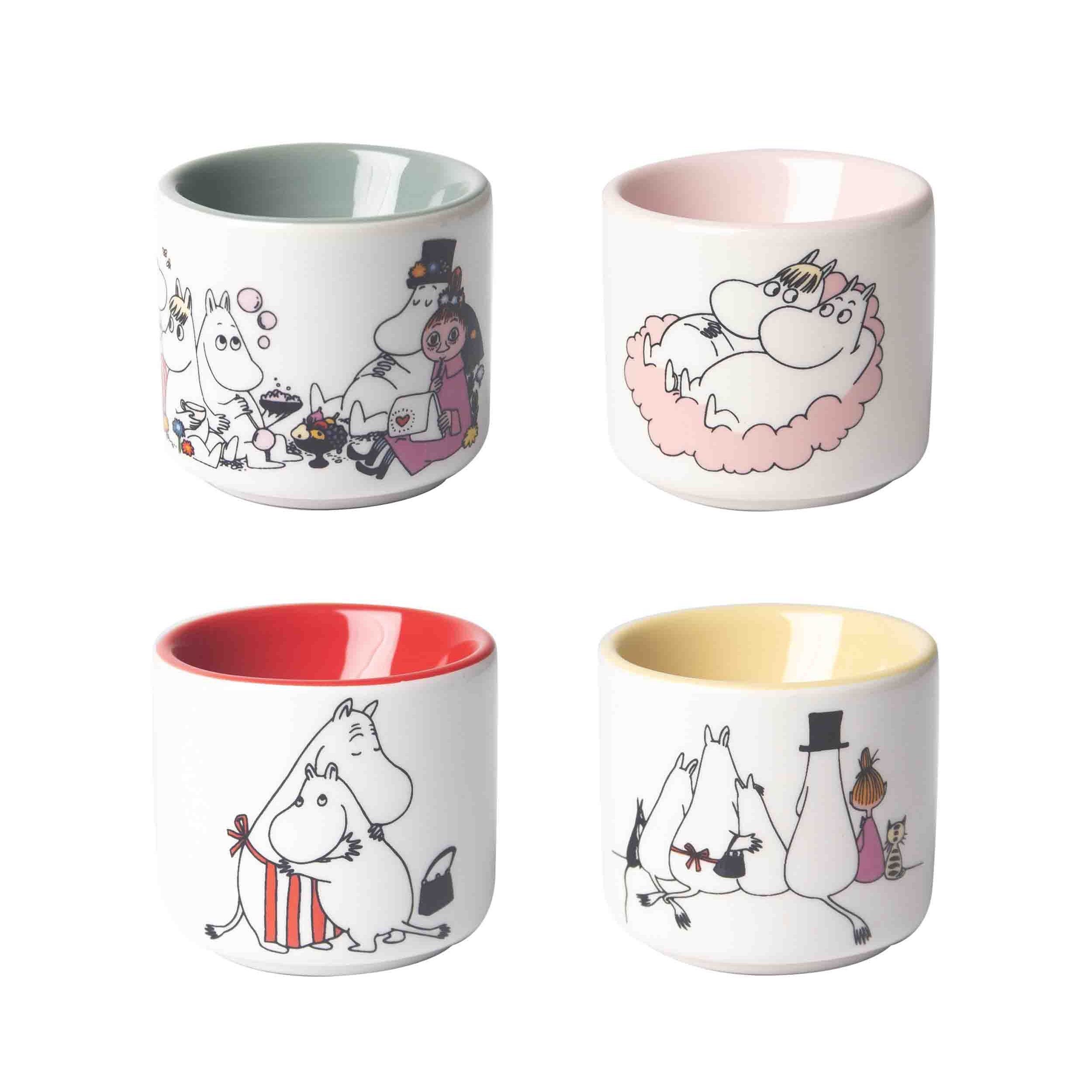 Set of four Moomin-themed ceramic mugs. Each mug features a different colored interior and a unique Moomin illustration.