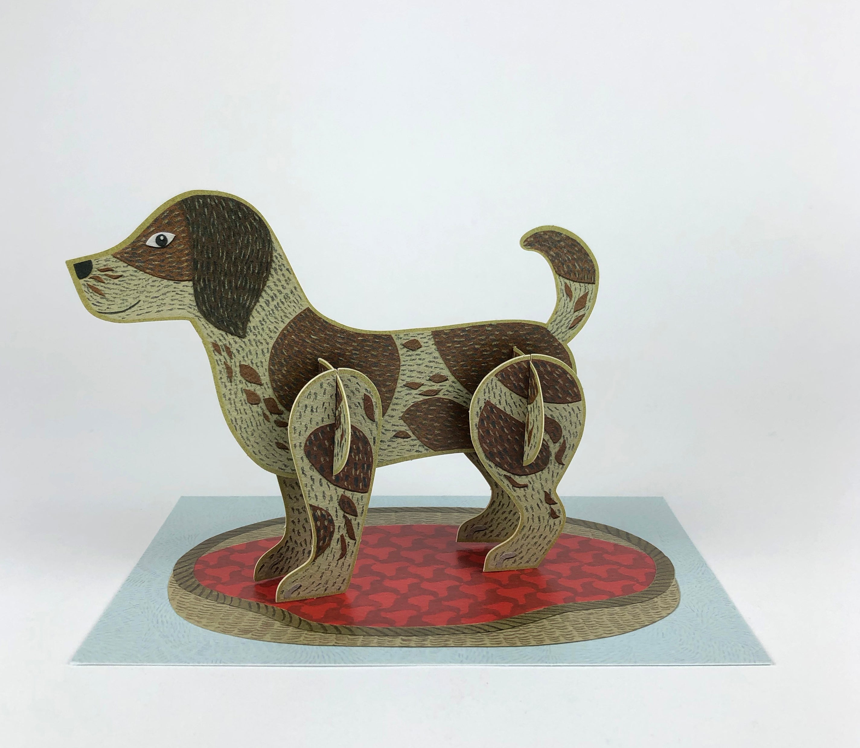 Pop-up card featuring a brown and tan spotted dog standing on a red and tan patterned base.