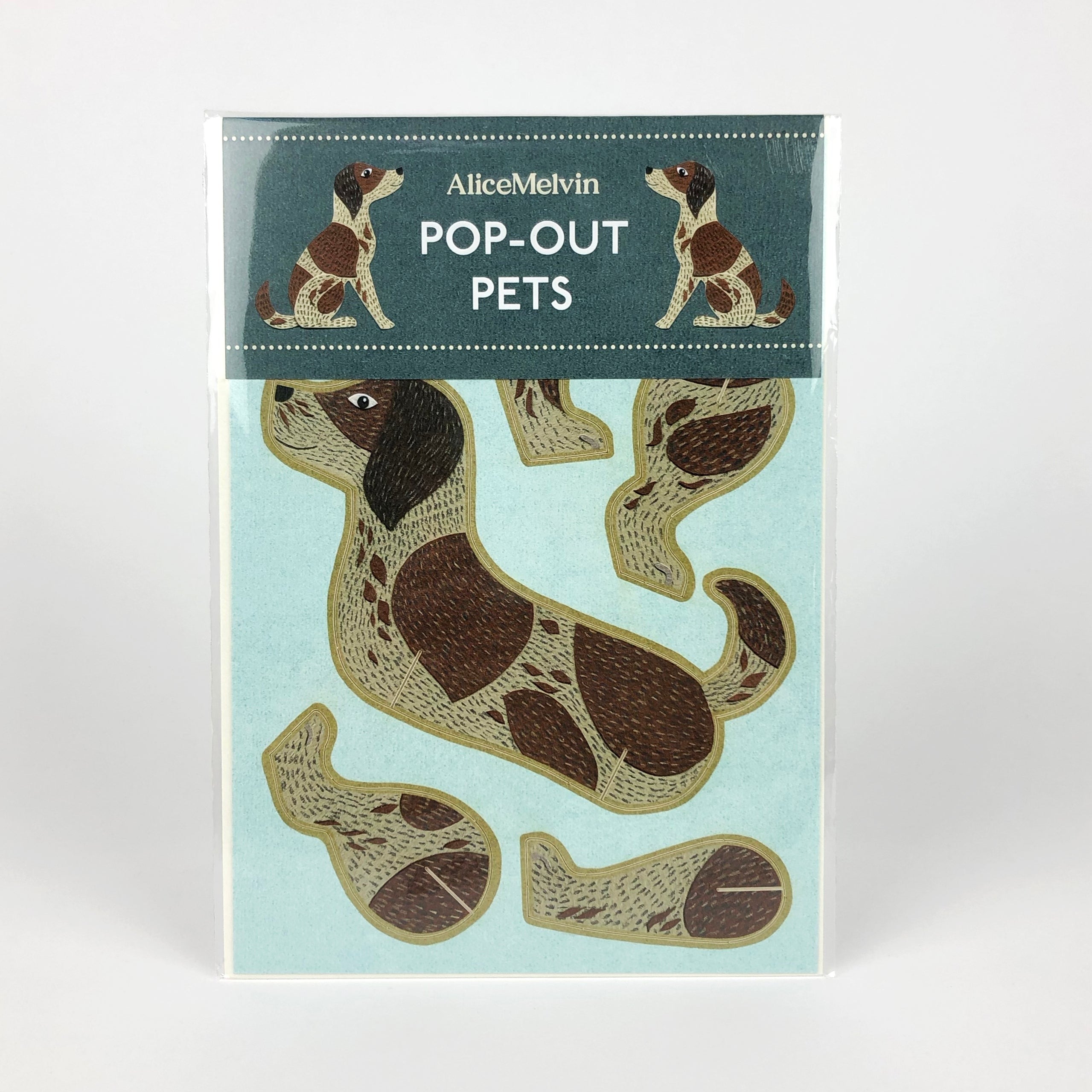 Alice Melvin Pop-Out Pets: A light teal card features a brown and tan spotted dog design, ready to be assembled.