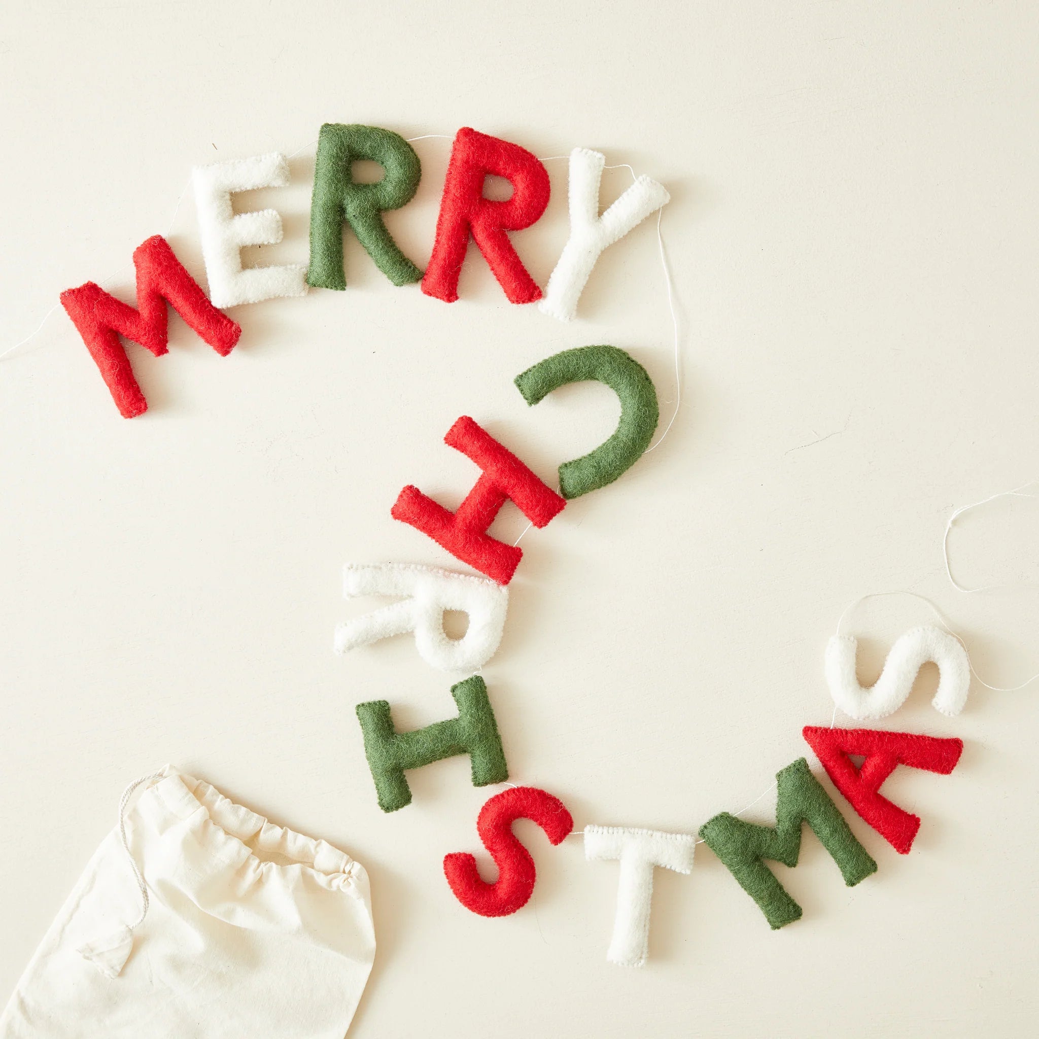 Felt Christmas banner spelling "Merry Christmas" in red, green, and white.
