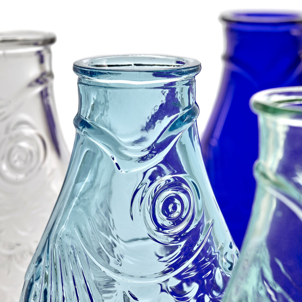 clear, blue, and dark blue pressed glass carafes, from the Fish & Fish tableware collection, by Italian designer Paola Navone, for Belgian design brand Serax.