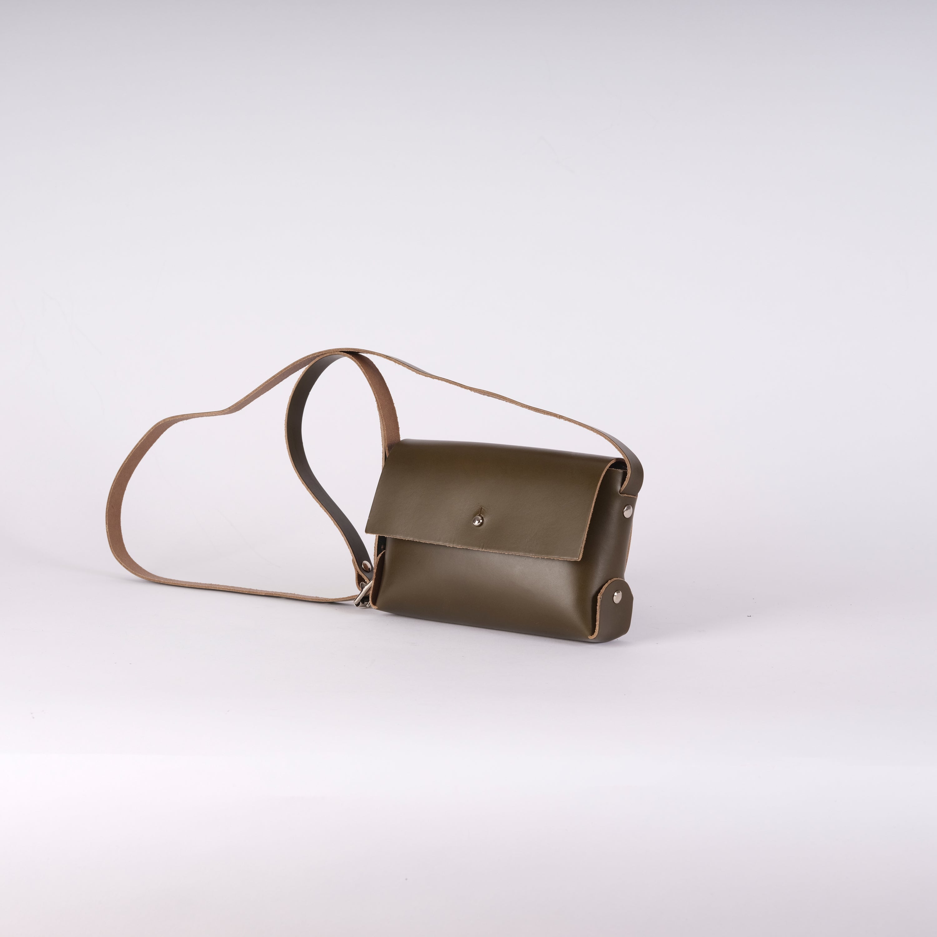 Olive green leather crossbody bag with a long brown strap and silver-toned hardware.