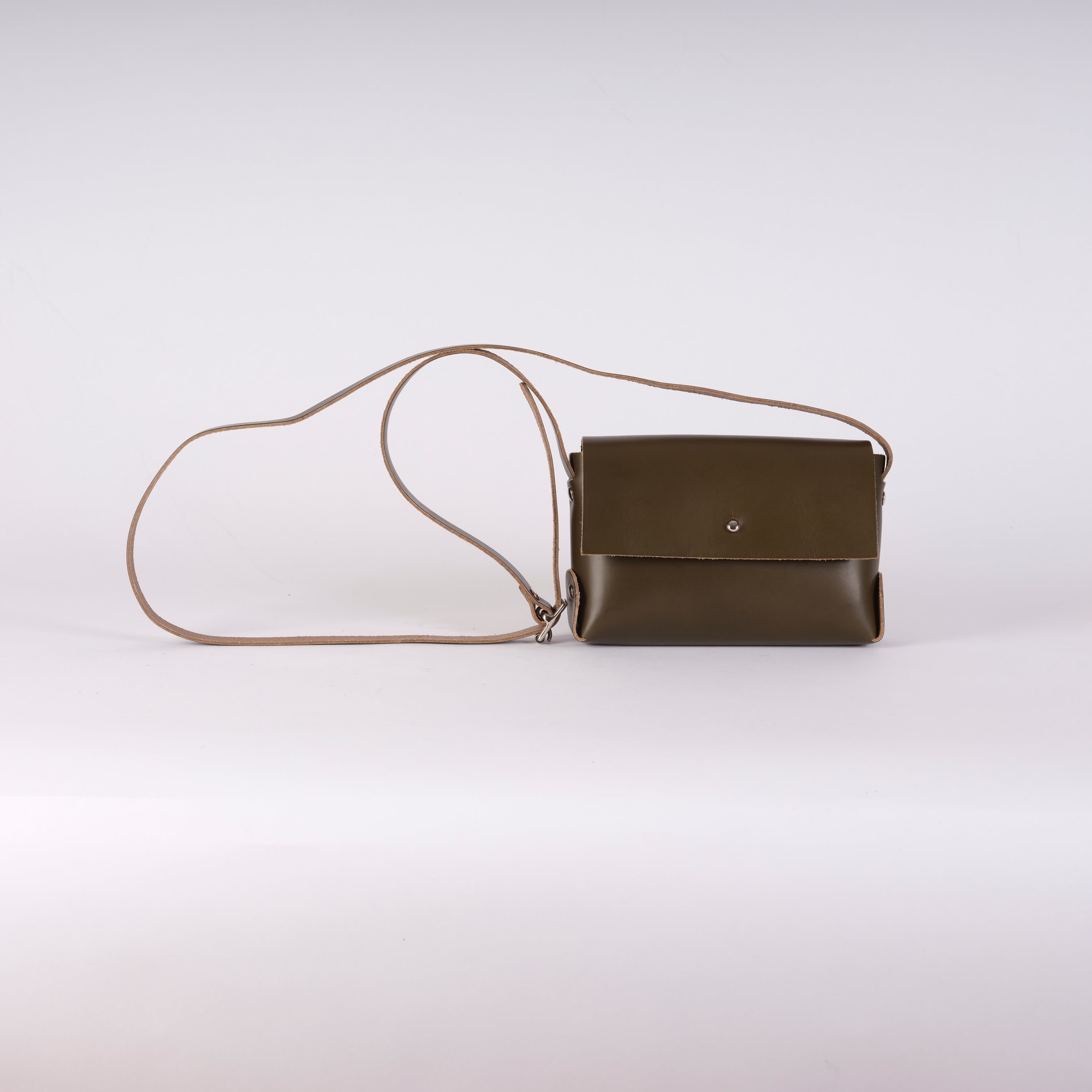 Olive green leather crossbody bag with a light brown shoulder strap.