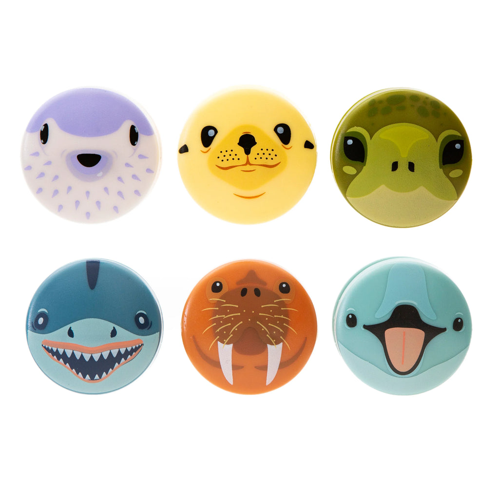 Six round, cartoon animal-faced cosmetic containers.  Designs include a pufferfish, seal, turtle, shark, walrus, and puffin.