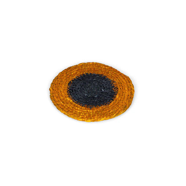 Round woven coaster with black center on a white background